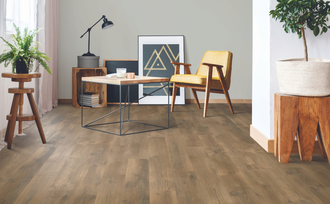 dark wood laminate flooring in living area with yellow chair and industrial coffee table
